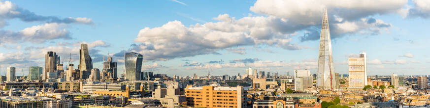 Panoramic view of the London skyline with iconic skyscrapers and clear blue sky