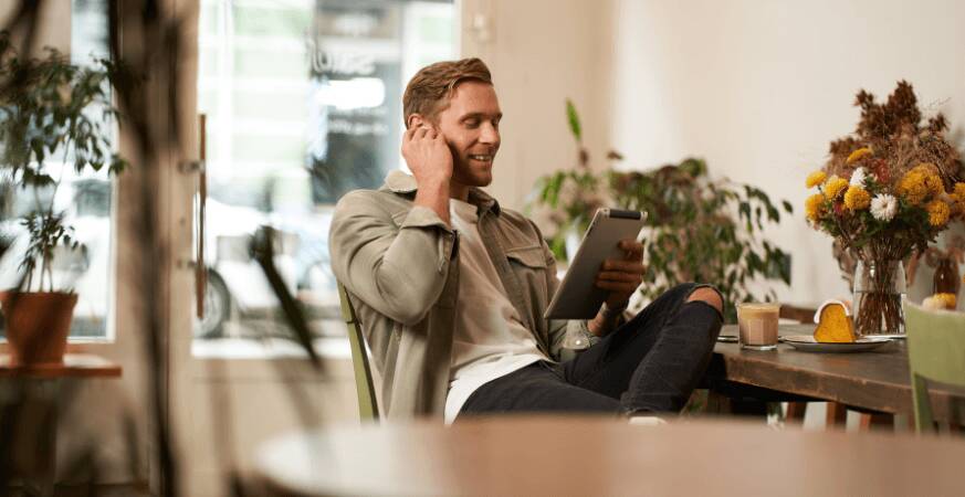man reading tablet on sofa